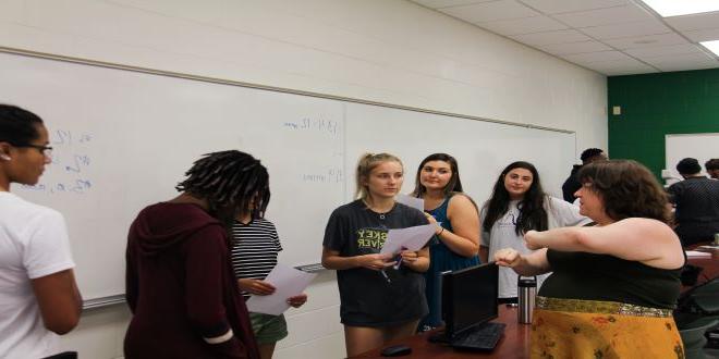 teacher teaching classroom of students