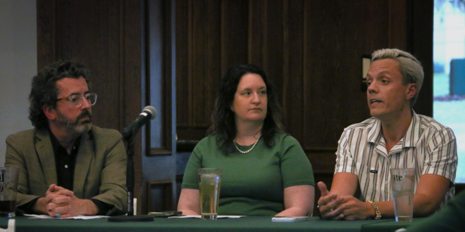 three people talking at a table