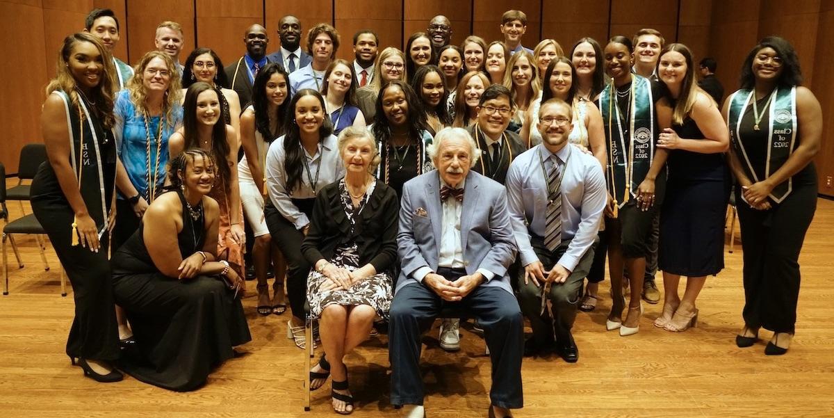 The Keigwins pose for a photo with the inaugural 12-month ABSN graduating class.