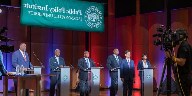 Candidates and Rick Mullaney on stage at the debate